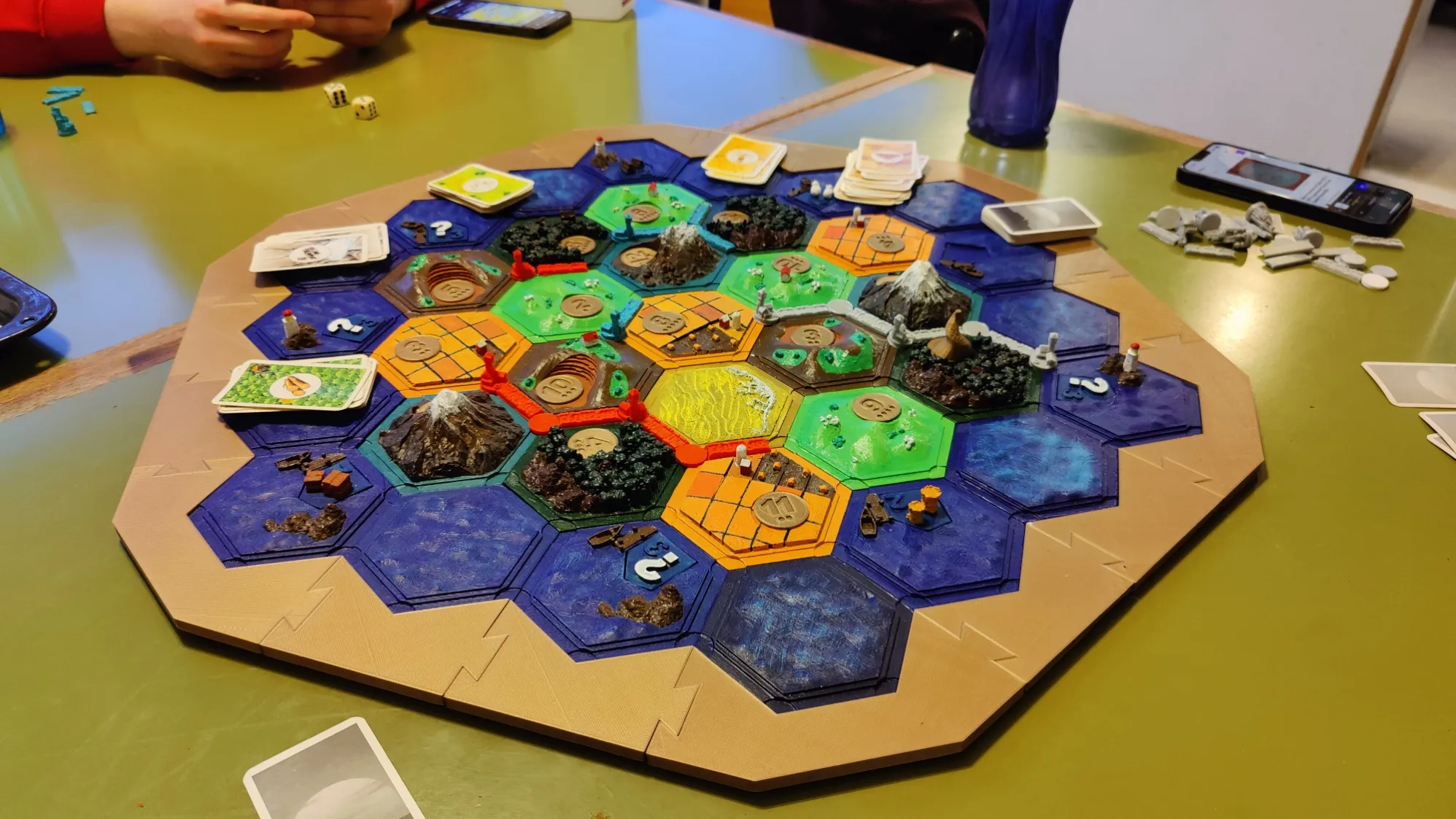 Painted 3D-printed Catan tiles laid out on a table